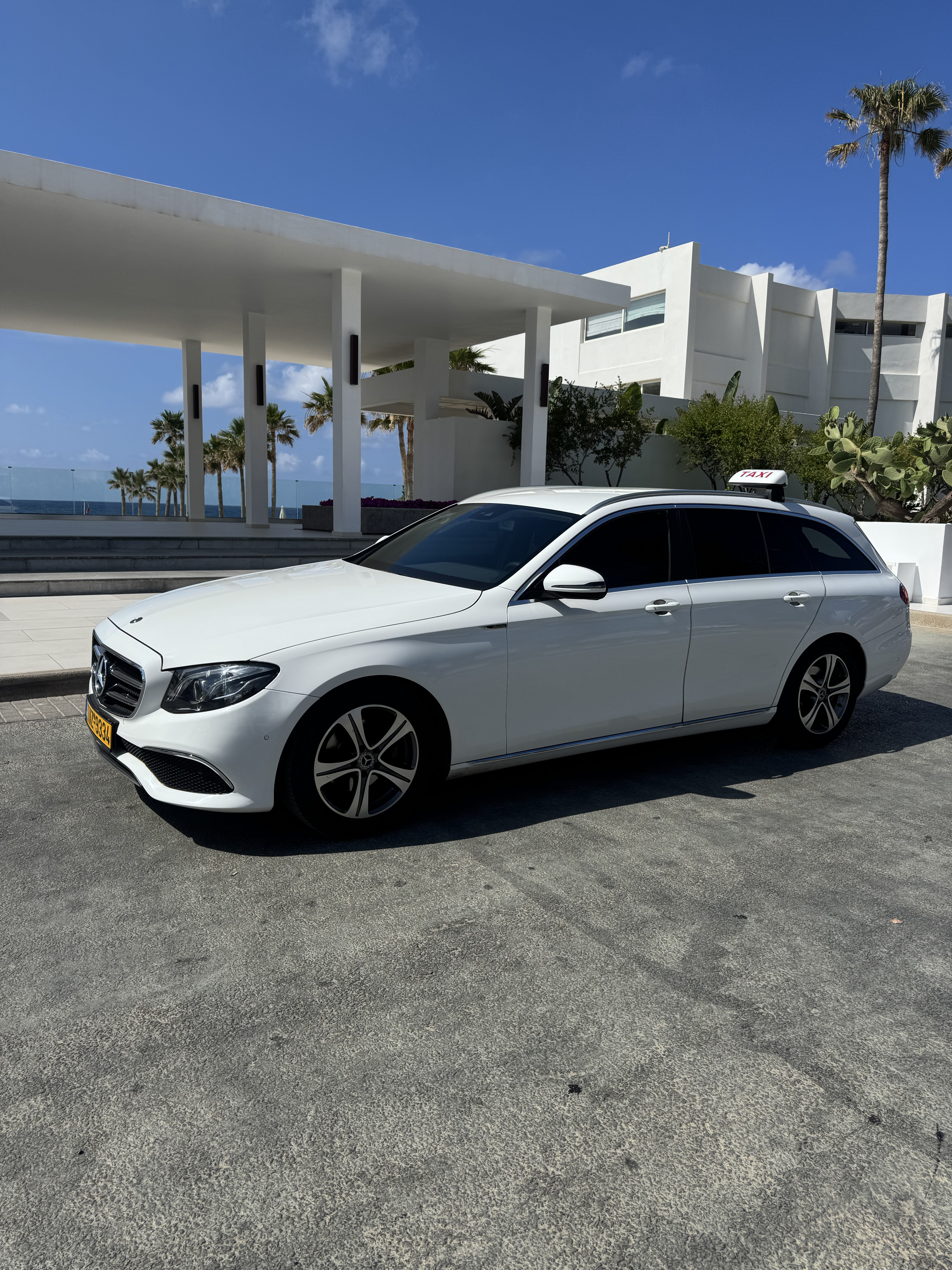 White Mercedes taxi vehicle in Crete